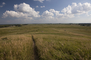 People hiking through the tall-grass prairie at Spirit Mount